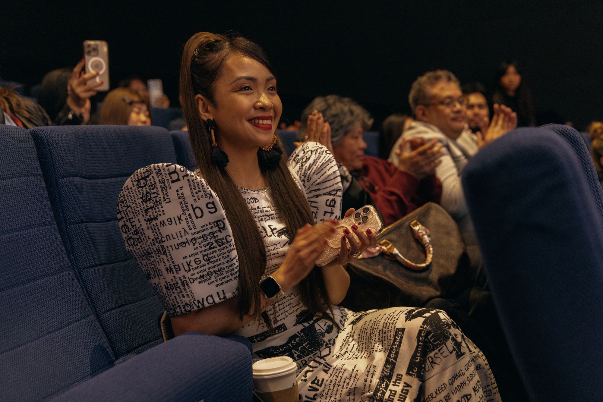 A guest applauding during a screening at Siné Film Fest