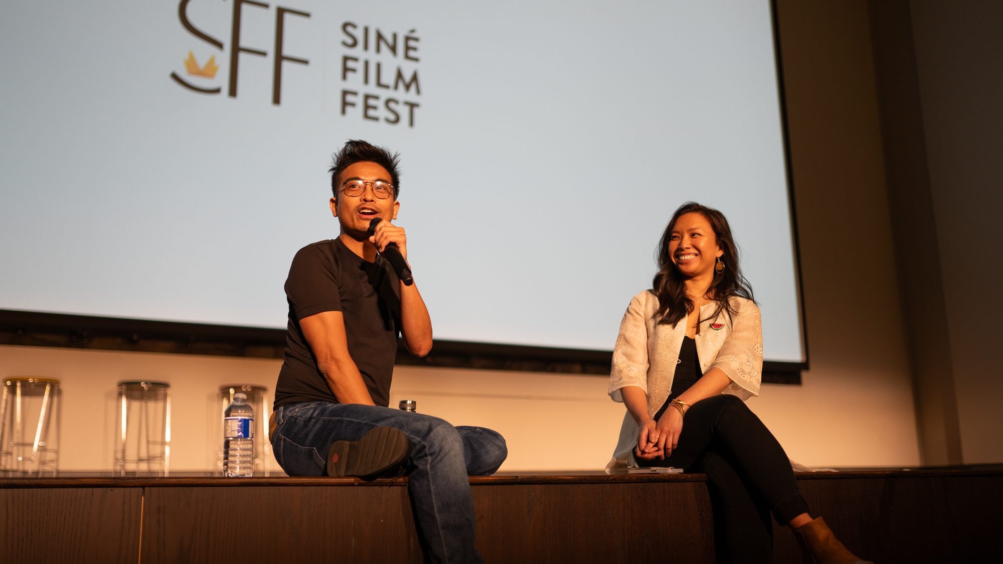 A filmmaker answers questions on stage during a Siné Film Fest Q&A